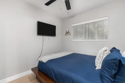 a bedroom with a bed and a flat screen tv at The General Sherman Cabin in Three Rivers