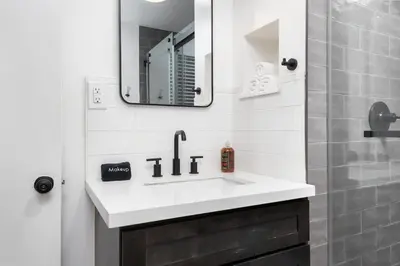 a bathroom with a sink and a mirror and a shower at The General Sherman Cabin in Three Rivers