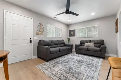 a living room with two leather chairs and a white door at The General Sherman Cabin in Three Rivers