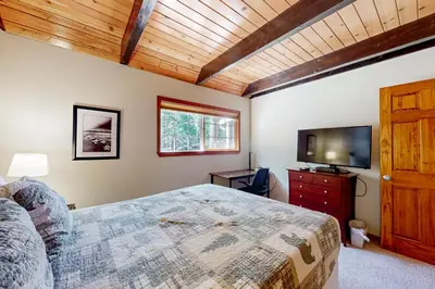 a bedroom with a bed and a flat screen tv at Mountain Escape in South Lake Tahoe