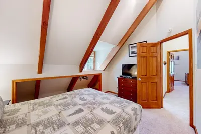 a attic bedroom with a bed and a tv at Mountain Escape in South Lake Tahoe