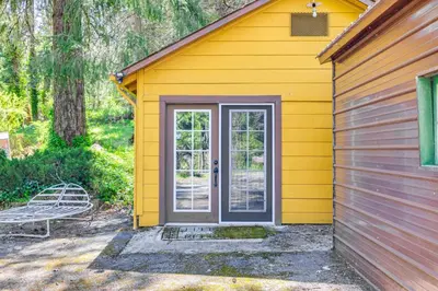 a yellow house with a door and a bench at On-Site River Access Quiet Home in Wilseyville! in Wilseyville