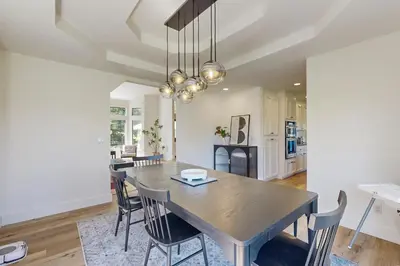 a dining room and kitchen with a table and chairs at Fair Days on the Fairway in Groveland