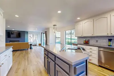 a large kitchen with white cabinets and a kitchen island at Fair Days on the Fairway in Groveland