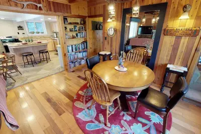 a kitchen and dining room with a wooden table and chairs at Baxter Mountain Cottage in Shaver Lake