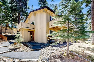 a house in the woods with a tree at Sierra Tranquility in Incline Village