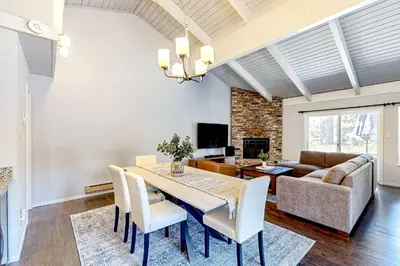 a dining room with a table and chairs and a couch at Sierra Tranquility in Incline Village