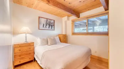 a bedroom with a white bed and a window at Lake Beach Access Pool Tennis Walk to Chambers Tahoe Timber by AvantStay in Homewood