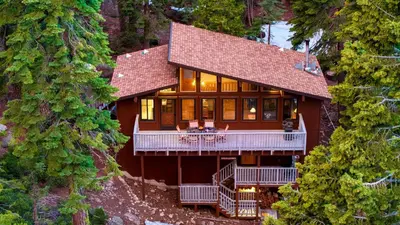an aerial view of a large house with a deck at Lake Beach Access Pool Tennis Walk to Chambers Tahoe Timber by AvantStay in Homewood