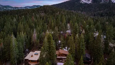 an aerial view of a house in the middle of a forest at Lake Beach Access Pool Tennis Walk to Chambers Tahoe Timber by AvantStay in Homewood