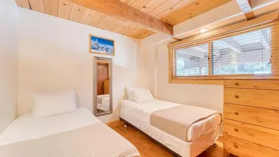 a bedroom with two beds and a dresser and a window at Lake Beach Access Pool Tennis Walk to Chambers Tahoe Timber by AvantStay in Homewood