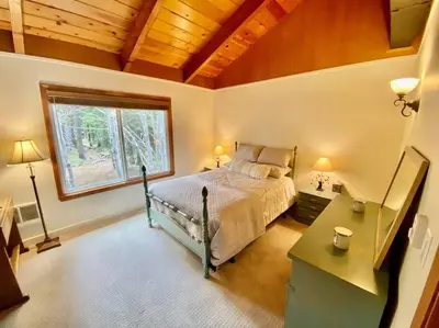 a bedroom with a bed and a window and a desk at Newly Renovated Family Lake House, Private Beach! in Tahoma