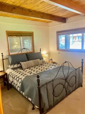 a bedroom with a bed in a room at Newly Renovated Family Lake House, Private Beach! in Tahoma