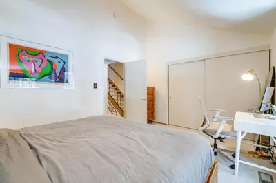 a bedroom with a bed and a desk and a sink at Steps to Lake Scenic Carnelian Bay Retreat in Carnelian Bay