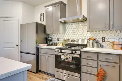 a kitchen with stainless steel appliances and white cabinets at Spacious Family Home in Stockton - Pets Welcome! in Stockton
