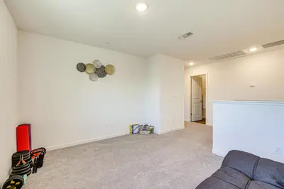 a living room with a couch and a white wall at Spacious Family Home in Stockton - Pets Welcome! in Stockton