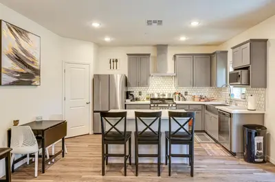 a kitchen with a table and chairs and a counter top at Spacious Family Home in Stockton - Pets Welcome! in Stockton