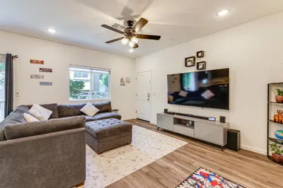 a living room with a couch and a flat screen tv at Spacious Family Home in Stockton - Pets Welcome! in Stockton
