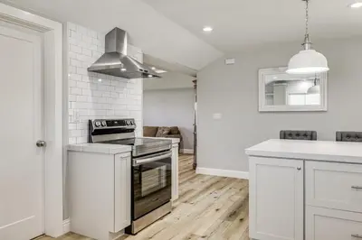 a kitchen with white walls and a stove top oven at Quaint Hughson Vacation Rental, Walk to Downtown! in Hughson