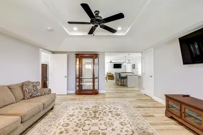 a living room with a couch and a ceiling fan at Quaint Hughson Vacation Rental, Walk to Downtown! in Hughson