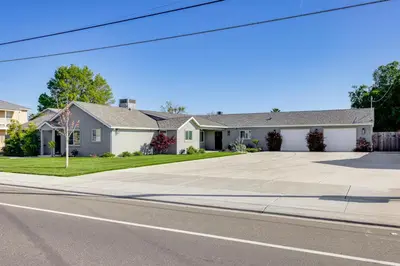 a house on the side of a street at Pet-Friendly Hughson Getaway, 9 Mi to Modesto! in Hughson