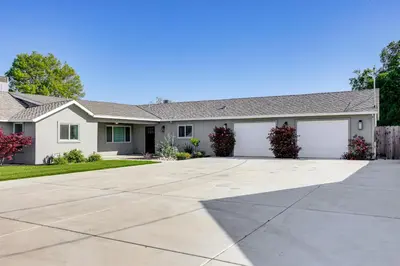 a house with a driveway at Pet-Friendly Hughson Getaway, 9 Mi to Modesto! in Hughson
