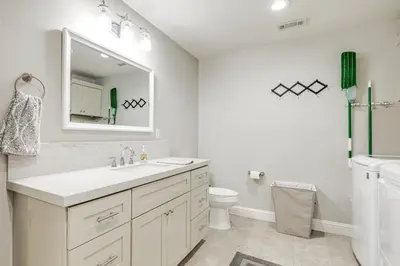 a white bathroom with a sink and a toilet at Pet-Friendly Hughson Getaway, 9 Mi to Modesto! in Hughson