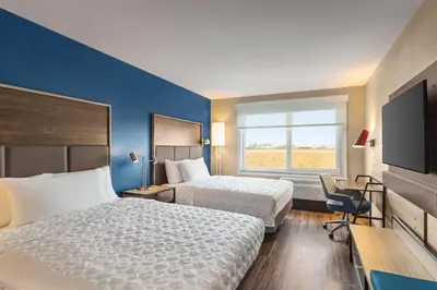 a hotel room with two beds and a flat screen tv at Tru By Hilton Lodi in Lodi