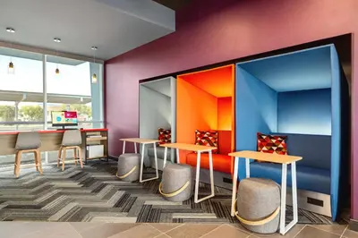 a waiting area with tables and chairs in a room at Tru By Hilton Lodi in Lodi