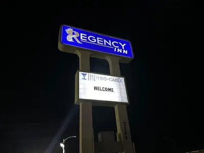 a sign for a regency inn on a pole at Regency Inn Fresno in Fresno