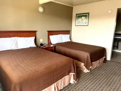 a hotel room with two beds in a room at Regency Inn Fresno in Fresno