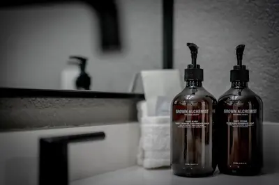 two glass bottles sitting on top of a sink at Luxurious 7BR Walk 2 Beach and Bus Stop in Carnelian Bay