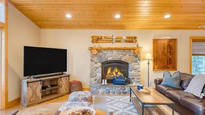 a living room with a tv and a fireplace at Washoe Chalet by AvantStay Game Room Hot Tub Putting Green Fire Pit in Tahoma