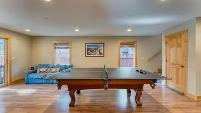 a living room with a pool table in it at Washoe Chalet by AvantStay Game Room Hot Tub Putting Green Fire Pit in Tahoma