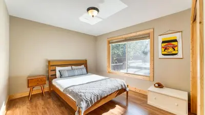 a bedroom with a bed and a window at Washoe Chalet by AvantStay Game Room Hot Tub Putting Green Fire Pit in Tahoma