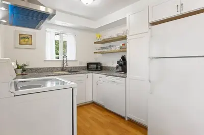 a white kitchen with a sink and a refrigerator at Trinity Escape Entire home near Lodi Lake in Lodi