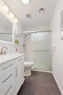 a white bathroom with a shower and a toilet at Trinity Escape Entire home near Lodi Lake in Lodi