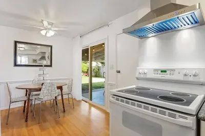 a kitchen with a stove and a table with chairs at Trinity Escape Entire home near Lodi Lake in Lodi