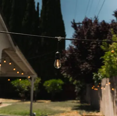a light hanging from a wire in a yard at Trinity Escape Entire home near Lodi Lake in Lodi