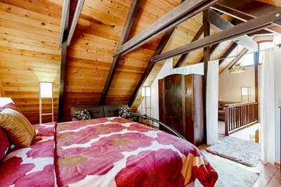 a bedroom with a bed in a room with wooden walls at The Venado House in Arnold