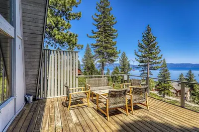 a patio with a table and chairs on a deck at 4BD with Lake Views Near Beach and Slopes in Tahoe City