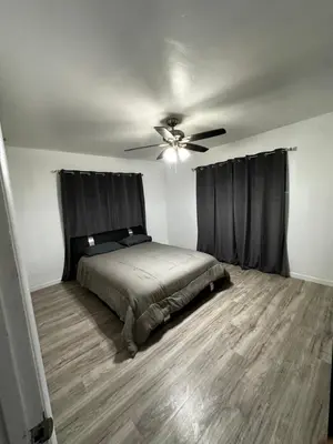 a bedroom with a bed and a ceiling fan at Casa Relajante in Visalia