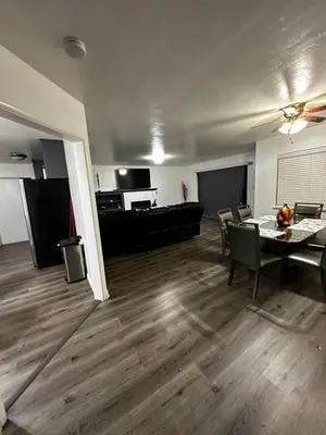 an empty living room with a table and chairs at Casa Relajante in Visalia