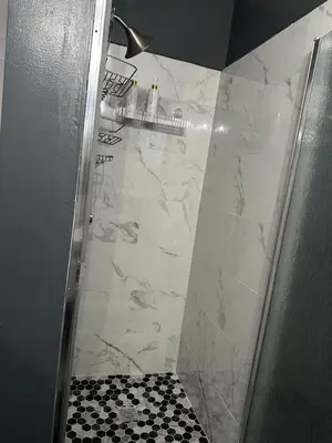 a shower with a black and white tile at Casa Relajante in Visalia