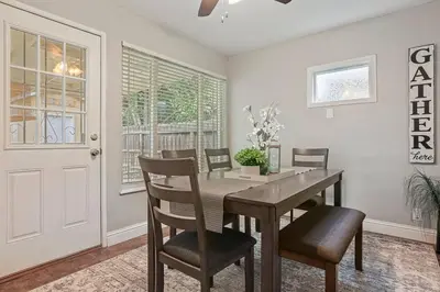 a dining room with a wooden table and chairs at Robert St Cottage, near Lodi Lake in Lodi