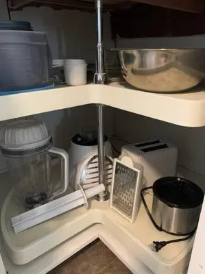 a kitchen shelf with various kitchen items on it at Robert St Cottage, near Lodi Lake in Lodi
