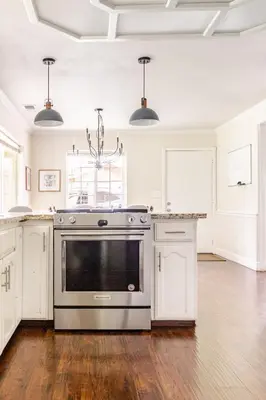 a kitchen with a stainless steel stove and white cabinets at Willow Nest - Sequoia And Kings Canyon Villa - Luxury In Nature in Hoffman Point
