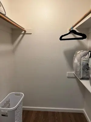 a laundry room with a laundry basket on a shelf at Serene 2bed 1bath condo with parking in Fresno