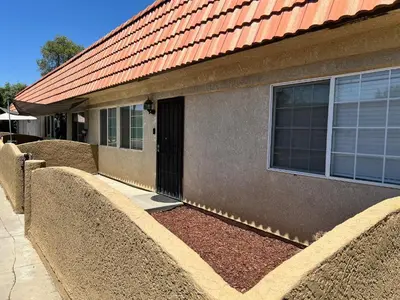 a house with stone barriers in front of a building at Serene 2bed 1bath condo with parking in Fresno
