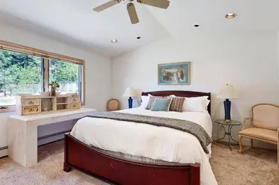 a bedroom with a large bed and a window at Livin' Lake Life in Incline Village